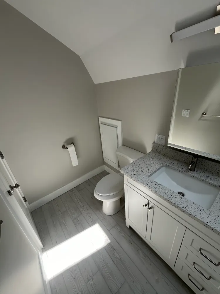 A renovated bathroom with a white vanity