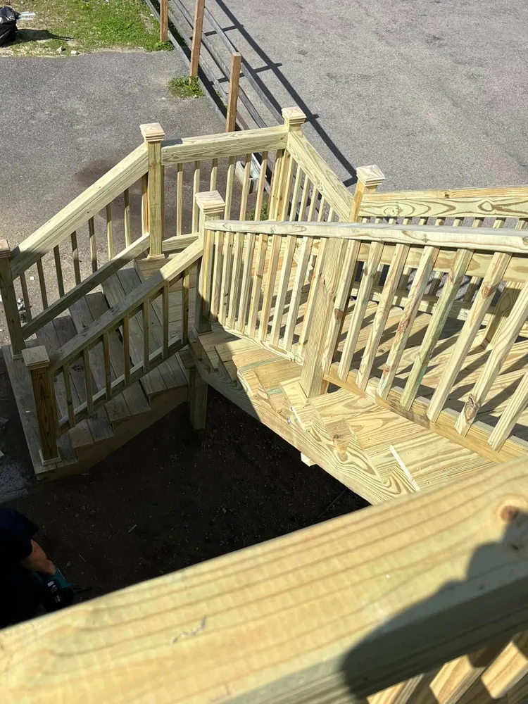 A new wooden deck with railings and stairs