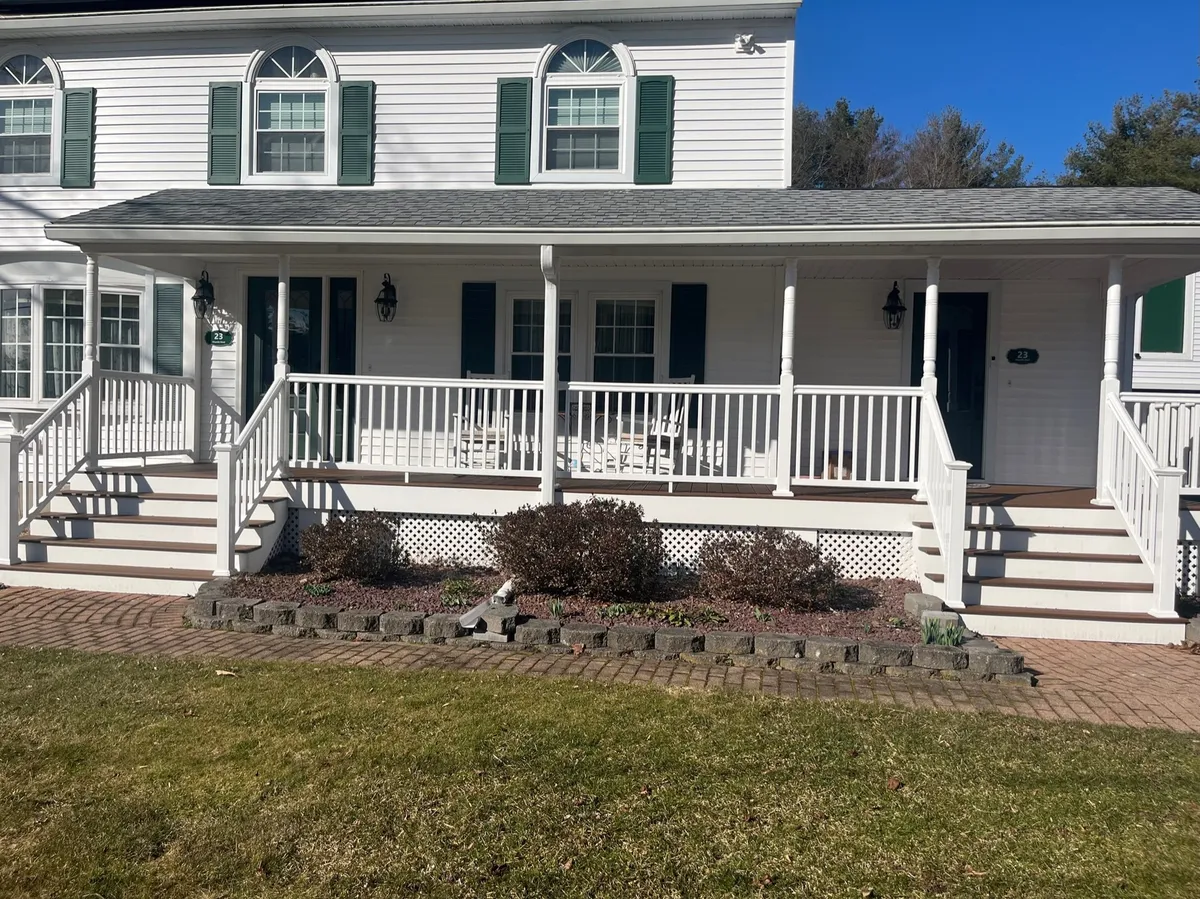 A house with a new white front porch, railings and steps