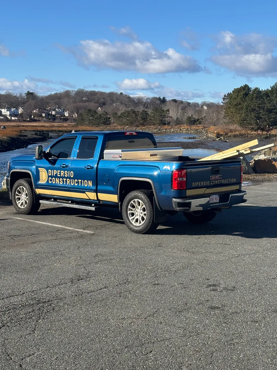 The DiPersio Construction pickup truck, navy with gold lettering